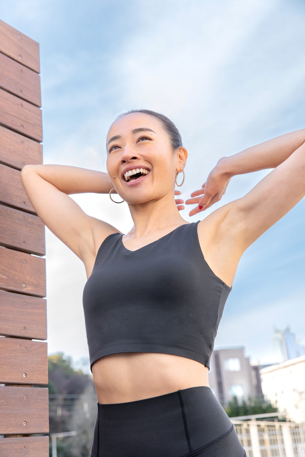 Kaoru stretching outdoors, smiling